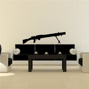Black machine gun with bipod wall decal above a sofa