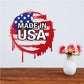 Grunge-style Made in USA sticker with red, white, and blue paint splatter text