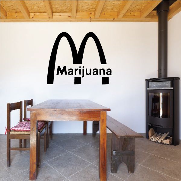 Marijuana M decal with black logo and bold text on a light wall