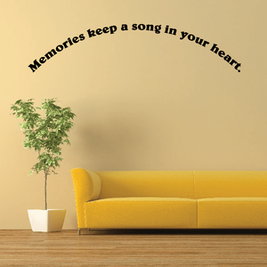 Wall decal with quote: “Memories keep a song in your heart” in black.
