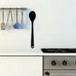 Metal spoon decal with black spoon shape and mounting holes