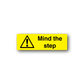 Yellow safety sticker with warning triangle and 'Mind the step'