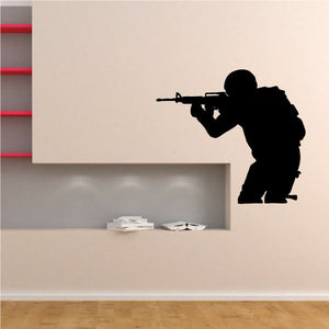 Shooting soldier wall decal with dark silhouette and rifle, removable vinyl sticker