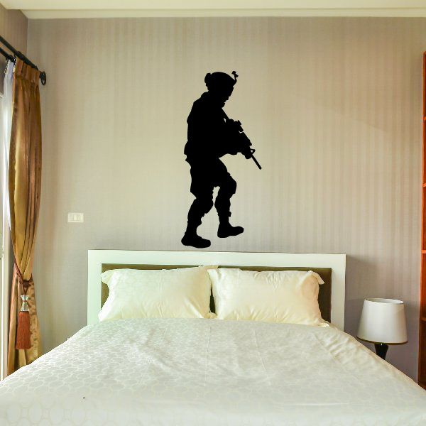 Modern soldier walking wall decal, black silhouette holding a rifle.