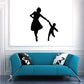 Wall decal with black silhouettes of a woman and a child playing