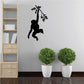 Black monkey hanging on tree branch wall decal