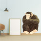 Origami monkey sitting sticker, brown geometric design with curled tail