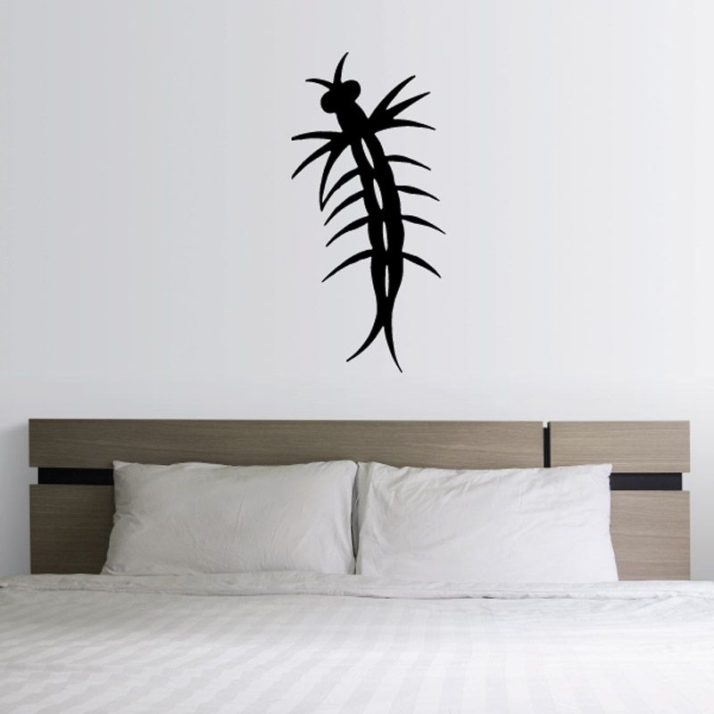 Mosquito larvae decal, black insect silhouette on light wall above bed