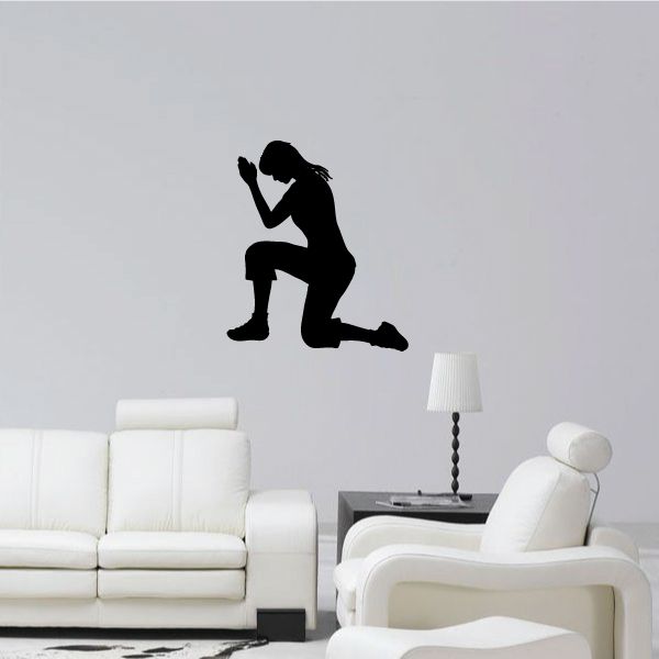 Silhouette wall decal of a woman praying on one knee