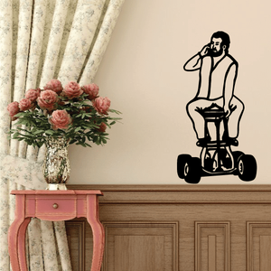 Black motorcycle wall decal of a rider holding a helmet, vinyl sticker