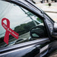 Maroon awareness ribbon vinyl sticker on car window, diagonal orientation