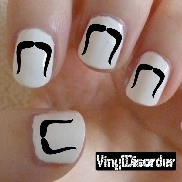 White nail decals with black mustache shapes on fingertips