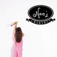 Black oval wall decal with Nan's Bakery lettering and flourishes