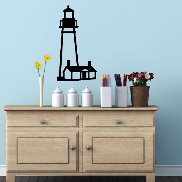 Black lighthouse wall decal with small buildings at the base