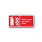 Red safety sticker with white extinguisher flames icon and text: Not for use on liquid fires.