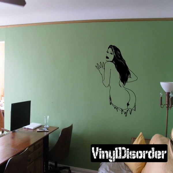 Black vinyl decal of nude woman bent over, tear-through style illustration