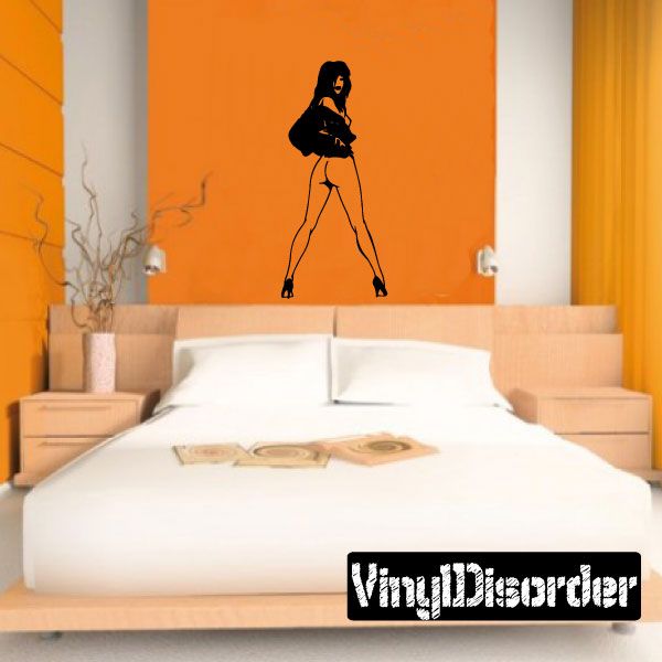 Wall decal of a nude woman in heels removing jacket, black silhouette