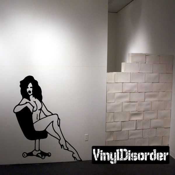 Office chair silhouette decal of a nude woman sitting with one leg crossed.