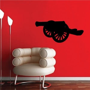 Old cannon wall decal, black silhouette with wheel detail.