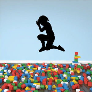 Prayer decal of a kneeling figure with open hands in prayer