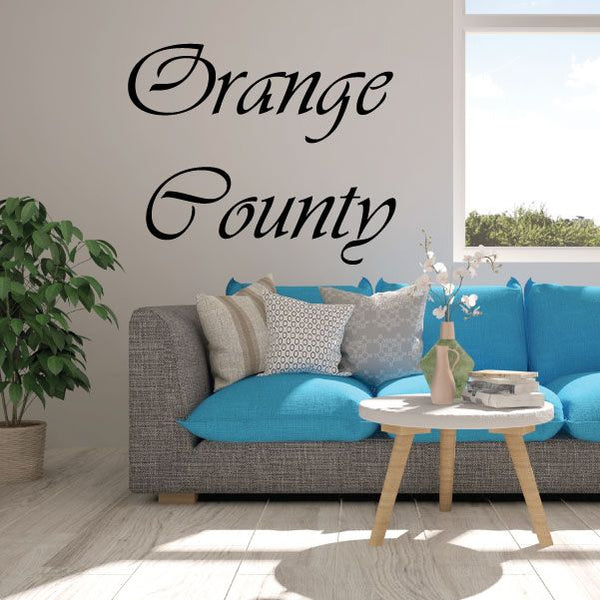 Cursive wall decal reading 'Orange County' in black ink