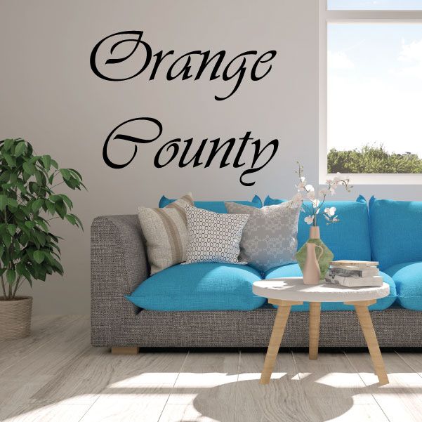 Cursive wall decal reading 'Orange County' in black ink
