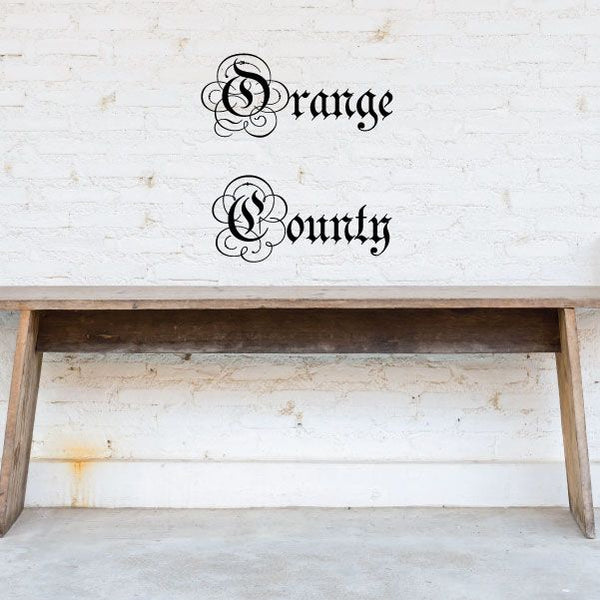 Ornate wall decal with black “Orange County” script letters