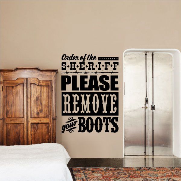Wall decal quote reading “Order of the Sheriff, please remove your boots”