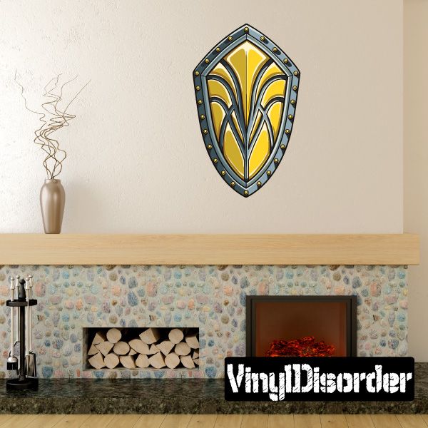 Ornamental kite shield sticker with yellow and blue emblem and dark studded border
