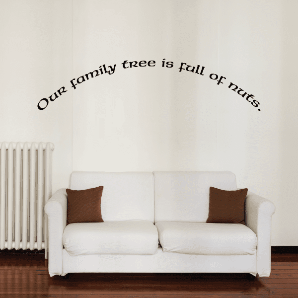 Wall decal with arched cursive text: "Our family tree is full of nuts"