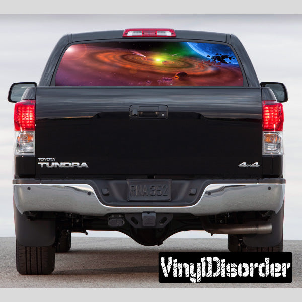 Pickup truck rear window with outer space graphic and black tailgate
