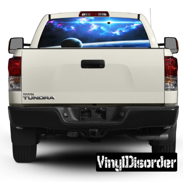 Vehicle rear window graphic on white pickup, blue outer-space design