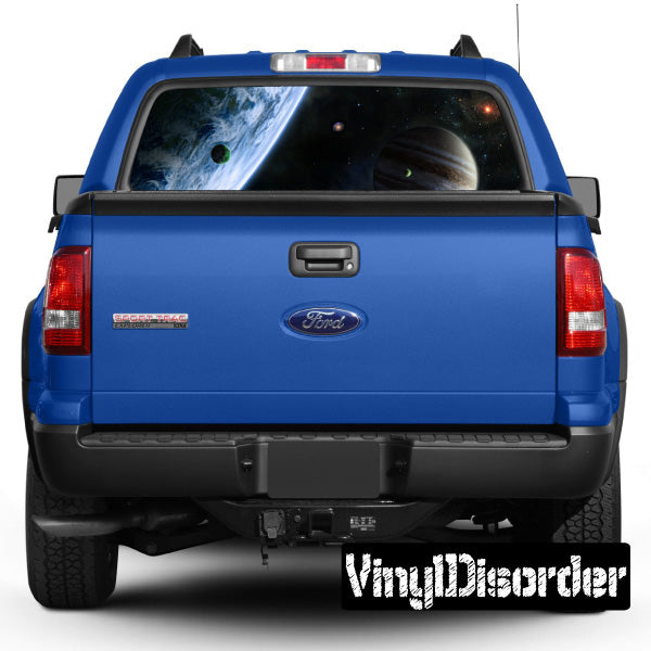 Blue pickup truck rear with outer space graphic on rear window and tailgate