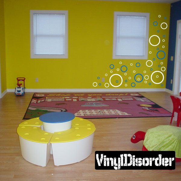 Outlined circle wall decals with concentric rings in yellow, blue, and white