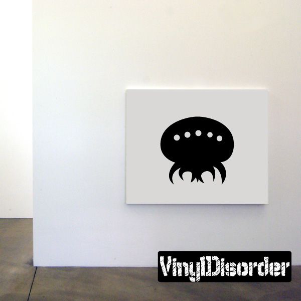 Black parasitic alien face decal on white backing