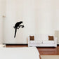 Dark parrot silhouette decal perched on a branch
