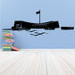 Memorial decal with black ship silhouette, flag, and blue wave design