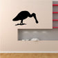Black pelican wall decal silhouette with legs and beak on smooth wall
