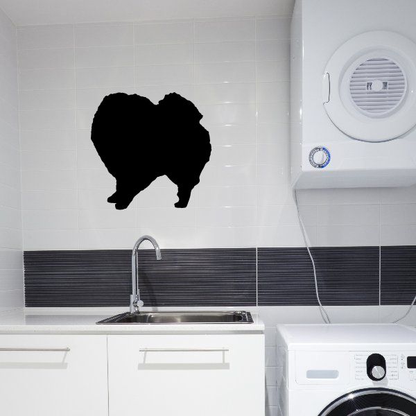 Pepper dog decal, black silhouette of a dog facing left on a flat surface.