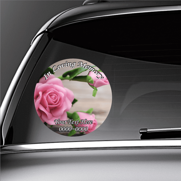 Round car memorial sticker with pink roses, green leaves, and “In Loving Memory” text