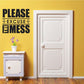 Black wall decal reading 'Please Excuse The Mess'
