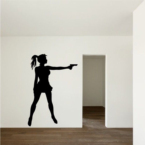 Black wall decal silhouette of a ponytail woman holding a handgun