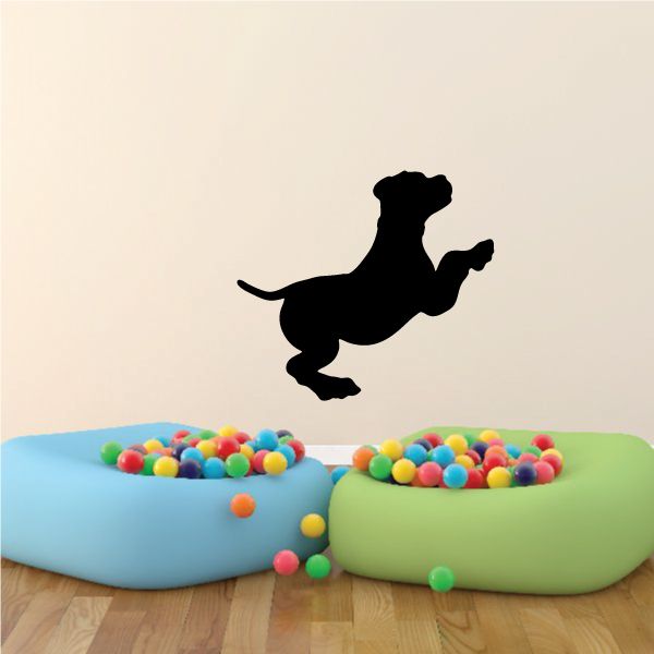 Pouncing puppy decal with black dog silhouette mid-leap