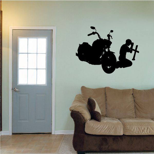 Motorcycle wall decal with rider kneeling in prayer beside a cross