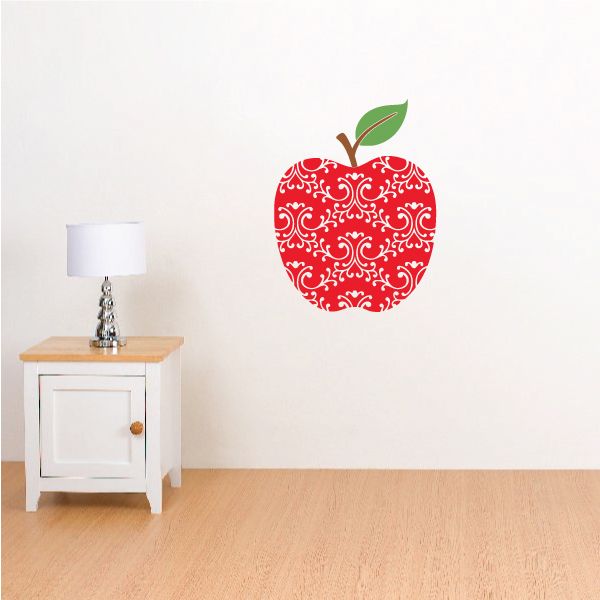 Red apple wall sticker with white scroll pattern and green leaf