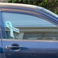 Light blue awareness ribbon vinyl sticker with text on car window