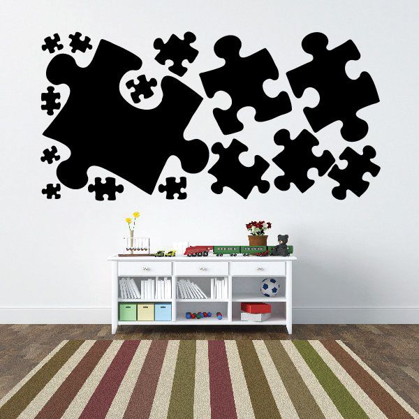 Puzzle wall decal kit with black jigsaw pieces in assorted shapes