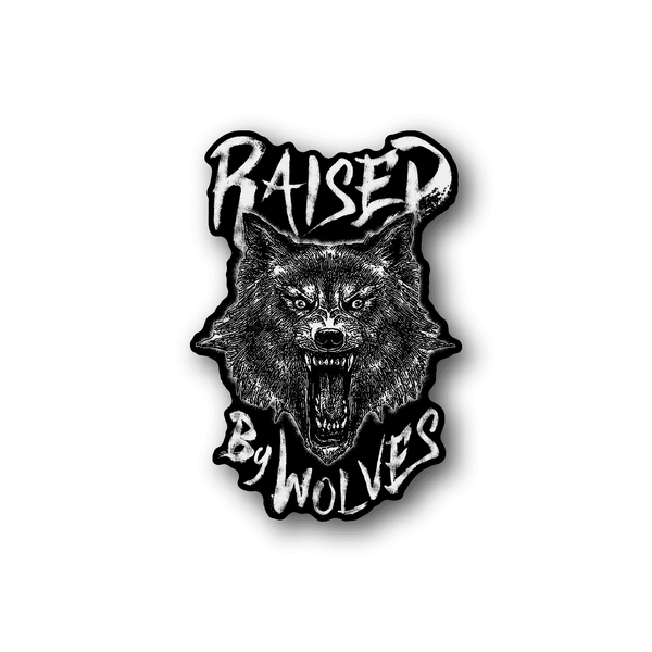 Vinyl sticker with white wolf head and raised lettering reading “Raised by Wolves”