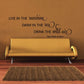 Wall quote decal with cursive black text: Live in the sunshine, swim in the sea