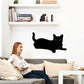Black cat relaxing decal with curled tail and open-eyed face
